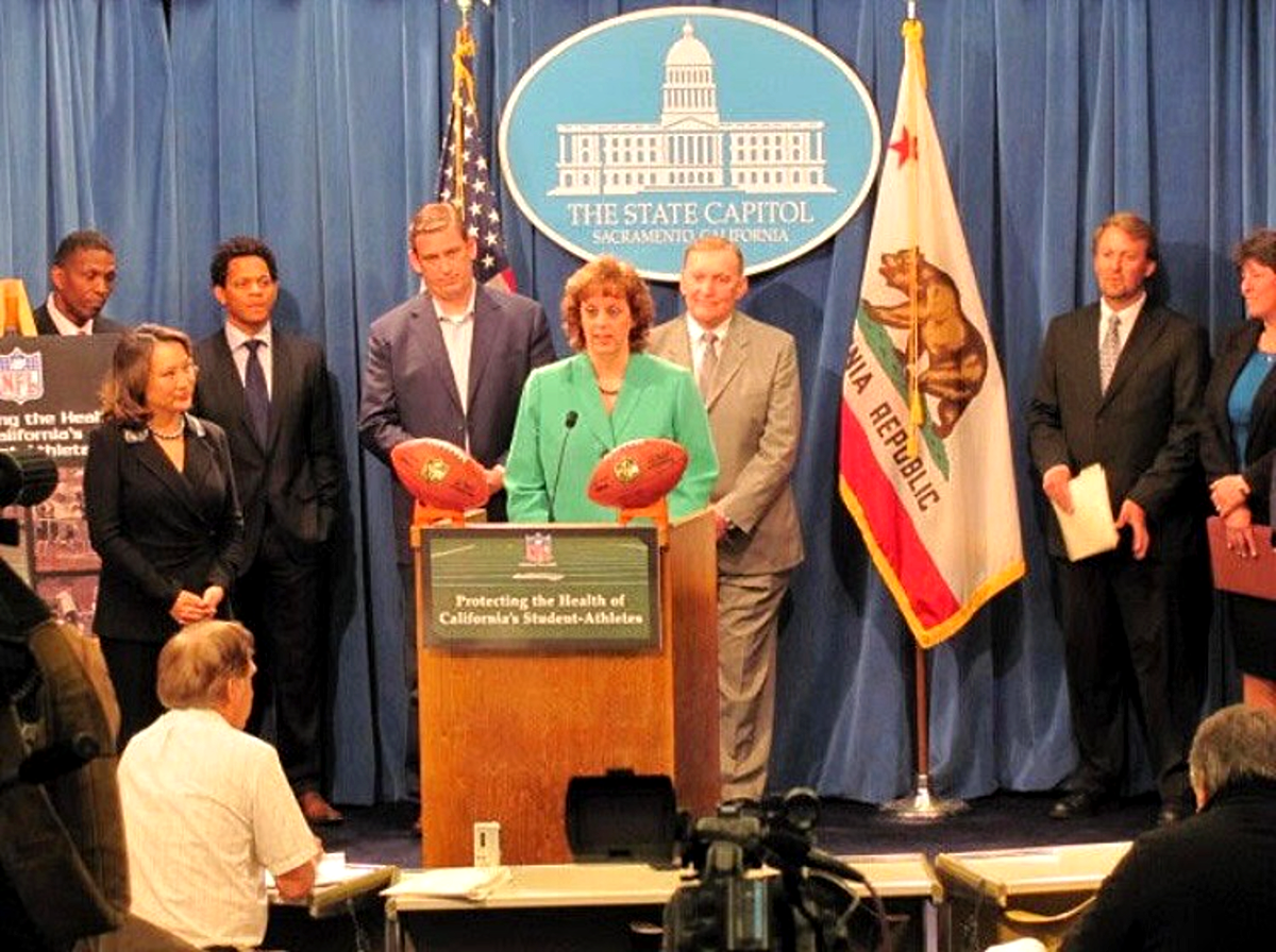 Paula Daoutis speaking at a State Capitol press conference in Sacramento