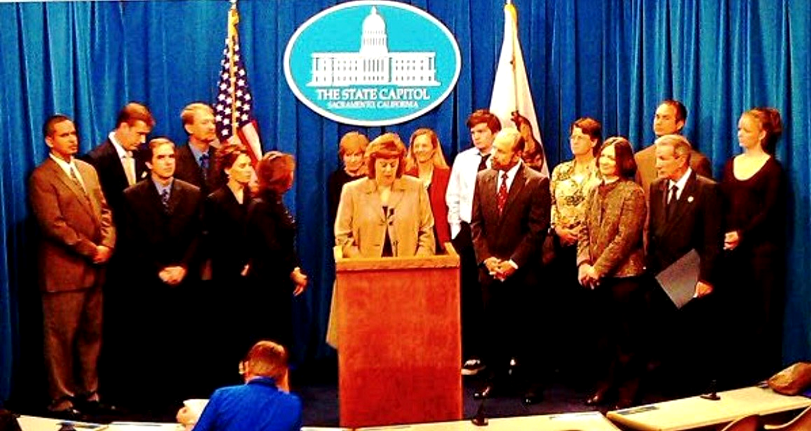 Paula Daoutis at the podium during a State Capitol press conference